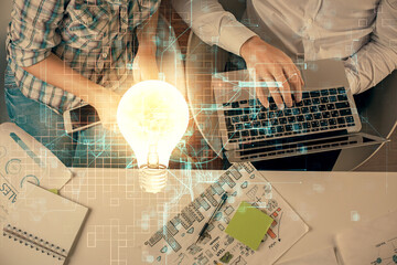 Double exposure of man and woman working together and bulb drawing. Computer background. Top View. Idea concept.