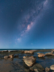Fototapeta na wymiar Milky way view over the rocky coastline of Coalcliff, NSW, Australia.