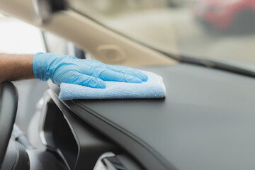 Man cleaning car with microfiber cloth