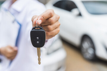 Businessman giving a car key. Getting new car.