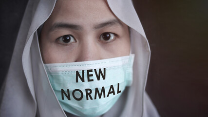 Muslim woman wearing mask to prevent coronavirus covid 19 pandemic, new normal