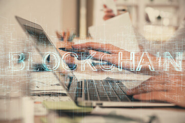 Double exposure of woman hands typing on computer and crypto market theme hologram drawing. Blockchain concept.