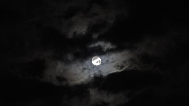 full moon moving between clouds, 4k