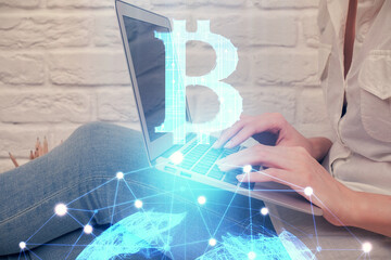 Double exposure of woman hands typing on computer and crypto market theme hologram drawing....