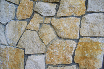 Wall of stone. Stones of various shapes and colors.