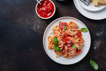 Traditional italian pasta with tomato, basil and parmesan