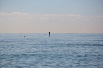 Fototapeta premium One person is sailing in the sea on a surfboard. Mallorca, Spain. Balearic Islands