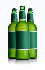 Cold frosted green bottle of beer with blank label on white background for print design and mock up