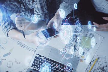 Double exposure of data theme hologram drawing and man and woman working together holding and using a mobile device.