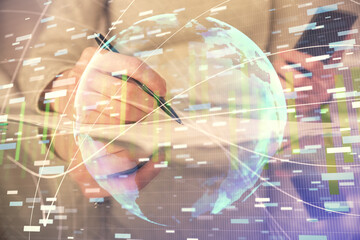 Double exposure of business theme sketch hologram and woman holding and using a mobile device.