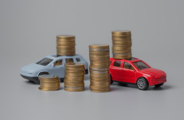 Mini car model with stack of golden coins,saving for car,loan and financial concept