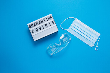 Inscription COVID-19 on blue background. Cube with the inscription. The inscription quarantine. The...