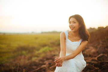 Portrait of beautiful woman smiling at park during sunset. Outdoor portrait of a smiling asian woman.