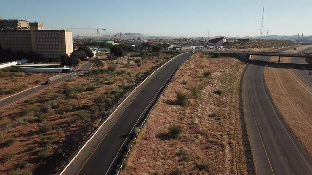 4K aerial drone summer sunny day video of Windhoek Katutura suburb large state hospital near B1 main highway in Namibia's capital in central highland Khomas Hochland of Namibia, southern Africa