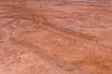 The texture of dry earth is red. View from above.