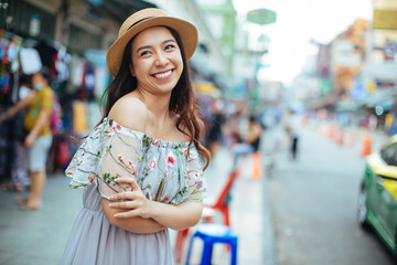 Sunny lifestyle fashion portrait of young stylish hipster woman walking on the street,wearing trendy outfit, straw hat, travel concept