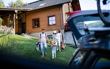 Family with two small children going on cycling trip in countryside.