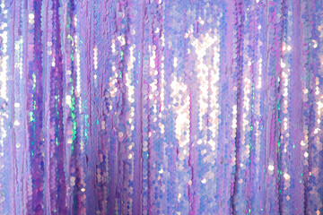 fabric of purple shiny sequins. textural background.