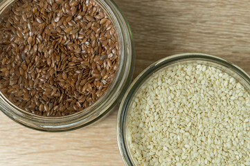 flax and sesame seeds in glass jars top view