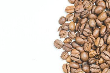 roasted coffee beans on a white background top view, space for text on the left
