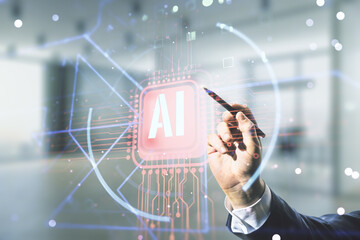 Double exposure of businessman hand with pen working with creative artificial Intelligence abbreviation hologram on blurred office background. Future technology and AI concept
