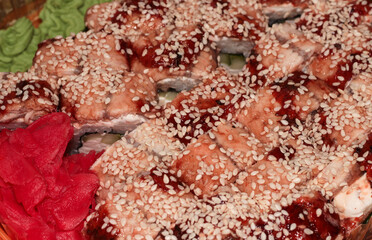 Hot sushi with eel and sesame. Japanese food. Wasabi ginger and baked sushi.