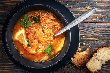 Red soup with vegetables and meat, tasty, appetizing traditional Ukrainian borsch, close-up, top view, shallow depth of field, selective focus. Healthy Home Food Concept
