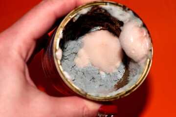 In the hand of the Bank with the spoiled food. Food with mold. Delayed goods. Poisonous food.