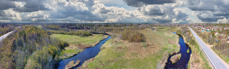 river between spring forest and meadow aerial view