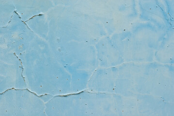 Texture of an old concrete wall with cracks. Blue wall with dirt and scratches.