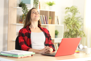 Student with laptop breathing fresh air at home