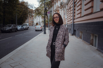 Obraz premium Beautiful young brunette woman walks in Moscow.