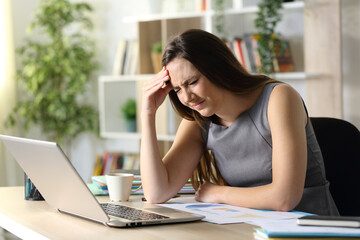 Entrepreneur suffering painful headache at homeoffice