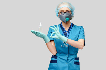 medical doctor nurse wearing protective mask - holding bottle of sanitizing spray or gel