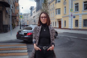 Beautiful young brunette woman walks in Moscow.