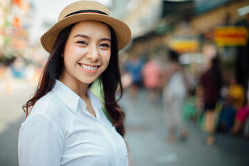 Sunny lifestyle fashion portrait of young stylish hipster woman walking on the street,wearing trendy outfit, straw hat, travel concept
