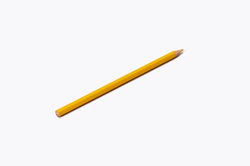 The yellow pencil lies diagonally on a white background. Isolate