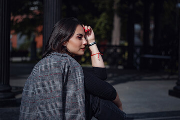 Beautiful young brunette woman walks in Moscow.