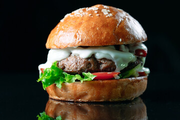 Juicy beef Burger on a black background.