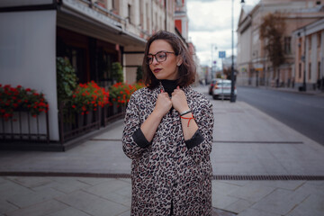 Beautiful young brunette woman walks in Moscow.