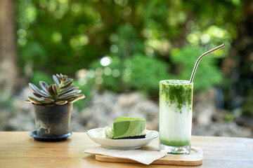 Close up matcha ice green tea on wooden table.