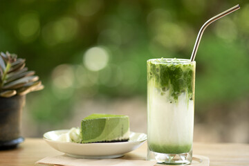 Close up matcha ice green tea on wooden table.