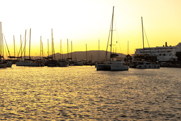 Boats in harbor during sunset.