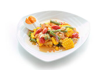 spicy Thai corn salad with salted egg and other vegetables isolated on white background. With clipping path.
