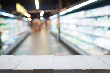 Wood top table on blur supermarket background