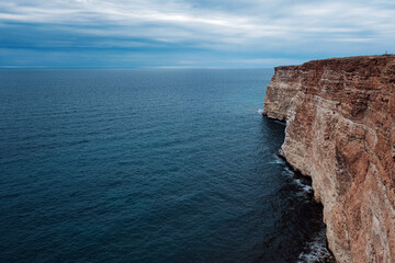 Picturesque seascape with rocky cliffs, stones, sea bay