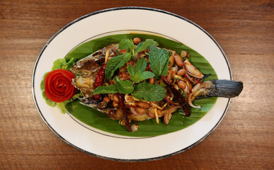Fried Snakehead Fish in Spicy Herb Salad. Thai Food. Top View.