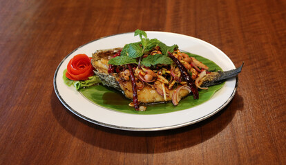 Fried Snakehead Fish in Spicy Herb Salad. Thai Food.