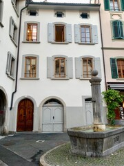 Old characteristic townhouse in the center of Vevey, Switzerland with fountain in the foreground.  no people.