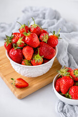 Fresh strawberries in a bowl on white table